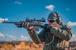 © EduardSkorov - Portrait of a shooter with a rifle. European shoots a rifle with a optics sight