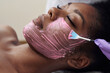 © etonastenka - Spa beauty treatment, skincare. Woman getting facial care by beautician at spa salon. Young cosmetologist applying facial mask by brush in spa