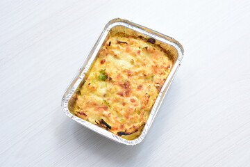 Sticker - Baked chicken and mushroom cannelloni, bathed in cream in cheese sauce gratin on white wooden background