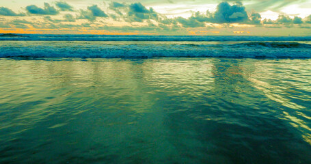 Wall Mural - beautiful panoramic view of Asian beach - sunset orange sky over Bali island in Indonesia in travel destination and exotic Summer holidays concept