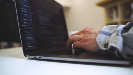 Wall Mural - Code on the laptop screen, working environment in the office of programmers