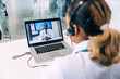 © Ivan - Shot of female doctor talking with colleagues through a video call with a laptop in the consultation