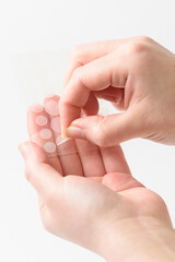 round patches for acne and wrinkles on the hands on a white background. acne and wrinkle patches for
