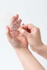 round patches for acne and wrinkles on the hands on a white background. acne and wrinkle patches for