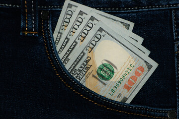 money in your pocket. dollar bills in jeans pocket. The concept of pocket money. Cash. American money, 100 dollar bills. Business, trade or financial transactions, seasonal discounts. close-up