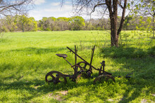 Old Rusty Farm Equipment In A Field