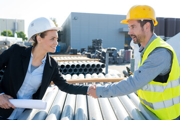 beautiful estate agent handshake with construction male