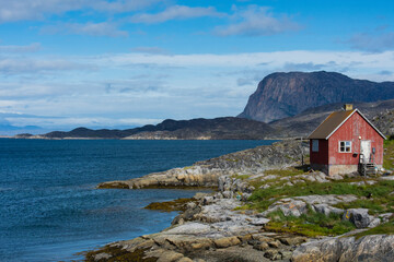 Poster - Greenland. Itilleq. Weather worn red house.