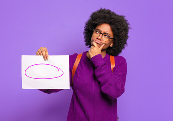 Wall Mural - young student afro woman thinking, feeling doubtful and confused, with different options, wondering which decision to make