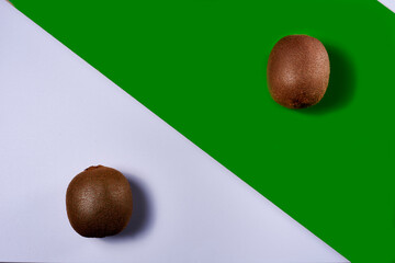 Two kiwis on white and green ground