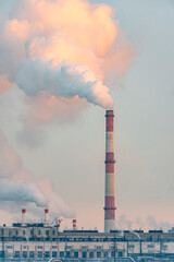 Emission to atmosphere from industrial pipes. Global warming concept and air pollution. Vertical photo