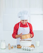 © be free - Look whats cooking. happy teen girl cooking dough. kid in chef uniform. culinary and cuisine.