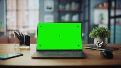 Poster - Laptop Computer with Mock Up Green Screen Display Standing on the Table in Cozy Living Room. In the Background Stylish Modern Bright Home Office Studio During Day with Big Cityscape Window.