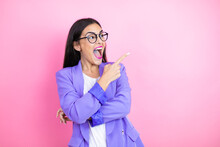 Young Business Woman Wearing Purple Jacket Over Pink Background Amazed And Pointing With Hand And Finger To The Side
