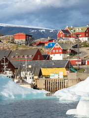 Wall Mural - Uummannaq harbor and town, northwest of Greenland, located on an island in the Uummannaq Fjord System.