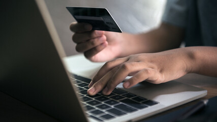 Hand holding a credit card, Payment for Shopping online.