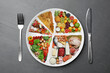 © New Africa - Cutlery near plate with different products on grey table, flat lay. Balanced food