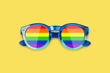 Sunglasses LGBTQ community flag colors yellow background close up, rainbow pattern glasses, LGBT pride people symbol, gay, lesbian etc love sign, human diversity concept, summer holidays fun accessory