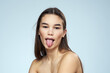 © SHOTPRIME STUDIO - Pretty brunette with bared shoulders long hair body care blue background