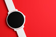 © Виталий Сова - 3d illustration white wrist watch with round black dial on red isolated background