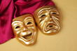 Comedy and tragedy masks with purple drapery