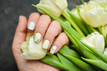 Women's Hands With A Colorful Patterns On The Nails. 2021 Colors Trend. Top View. A Place For Text. Spring Nails Concept.