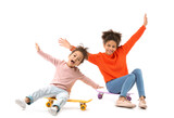Fototapeta  - Portrait of cute African-American sisters with skateboards on white background