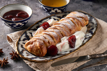 Wall Mural - Traditional tasty apple pie, strudel, served in a beautiful oriental plate