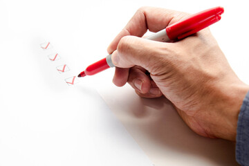 Checklist concept, Businessman checking mark on the check boxes using red marker. Copy space