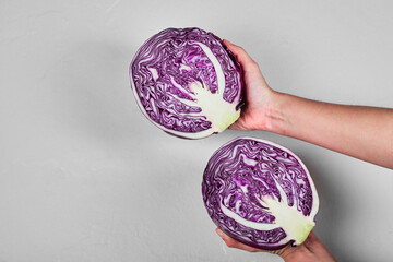 Wall Mural - Hand holding purple cabbage on the white background