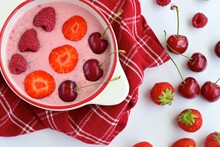 Breakfast Berry Smoothie Bowl Topped With Raspberry, Strawberry And Cherry On White Background