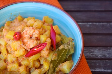 Wall Mural - Sambal goreng kentang udang. Fried cubed potato with prawns cooked with coconut milk and spices (Indonesian food)