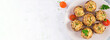 Baked mushrooms stuffed with chicken minced meat, cheese and herbs on light plate. Top view, banner, copy space