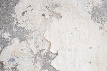 Old Wall Damaged With Blown Plaster And Paint Clog, Peeling Paint Damage, Water Damage On Building Wall. Grunge Abstract Background
