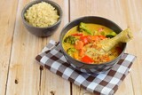 Fototapeta Kuchnia - Homemade chicken curry with carrot, broccoli and red bell pepper. Served with brown rice