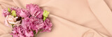 Bouquet of eustoma flowers on a beige cloth background. Minimal romantic concept with copyspace. Festive springtime composition.