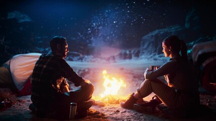 Wall Mural - Happy Couple Sitting by Campfire Sharing Cup of Drink, Watching Night Sky while Camping in the Canyon. Two Traveling Young people Tell Inspirational Stories about Life, Look at Milky Way Stars