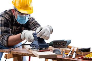 Wall Mural - Carpenter worker at work isolated on white background, wears helmet, goggles, leather gloves and surgical mask to prevent coronavirus infection. Preventing Pandemic Covid-19 at the workplace.