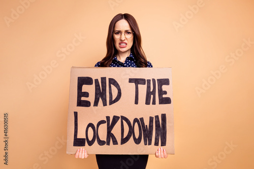 Photo of furious mad business lady in specs blouse showing card end lockdown isolated on beige color background