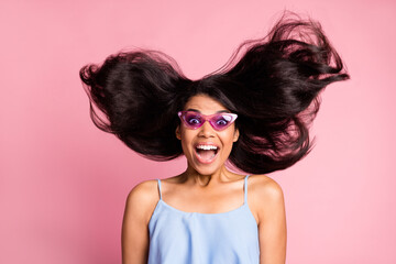 Wall Mural - Portrait of optimistic brunette lady blow wind wear spectacles blue top isolated on pastel pink color background