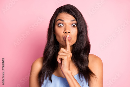 Portrait of scared brunette lady finger mouth wear blue top isolated on pastel pink color background