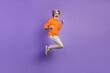 Full size profile side photo of mature man excited rejoice win victory jump up happy smile isolated over purple color background