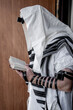 Religious jew with tefillin on his forehead and tallit on his head while praying (269)