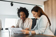 © bnenin - Two beautiful businesswomen working together in the office, portrait.