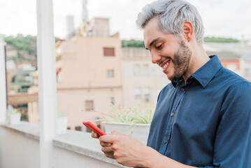 Young business man using mobile phone outdoors in the city - Focus on face