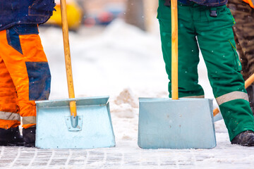 Wall Mural - Communal services workers sweep snow from road in winter, Cleaning city streets and roads during snowstorm. Moscow, Russia.