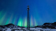 Telecommunication tower with 5G cellular network antenna on night winter landscape with aurora green northern lights