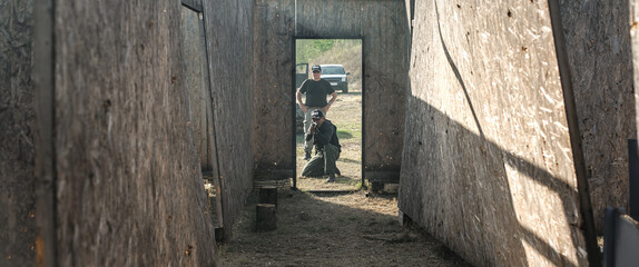 Military army soldiers in action tactical combat shooting from rifle machine gun. Shooting and weapons. Outdoor shooting range