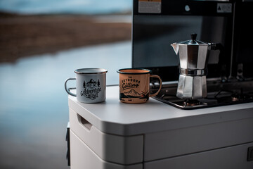 Cups of coffee in the kitchen of a motorhome, campervan and road life traveling concept