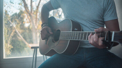 Guitarist in the recording studio composing a song. Concepts of singer-songwriter, electric guitar, band, learning, indie and alternative music